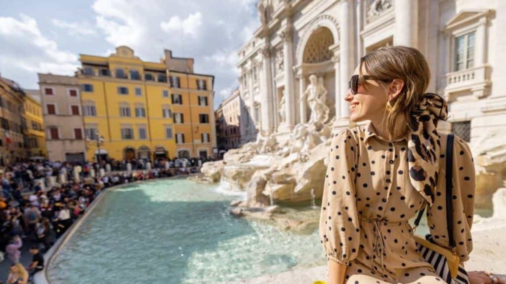 Woman sitting on the Trevi Fountain