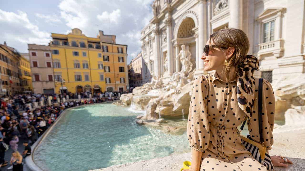 Woman in Trevi fountain in Rome.