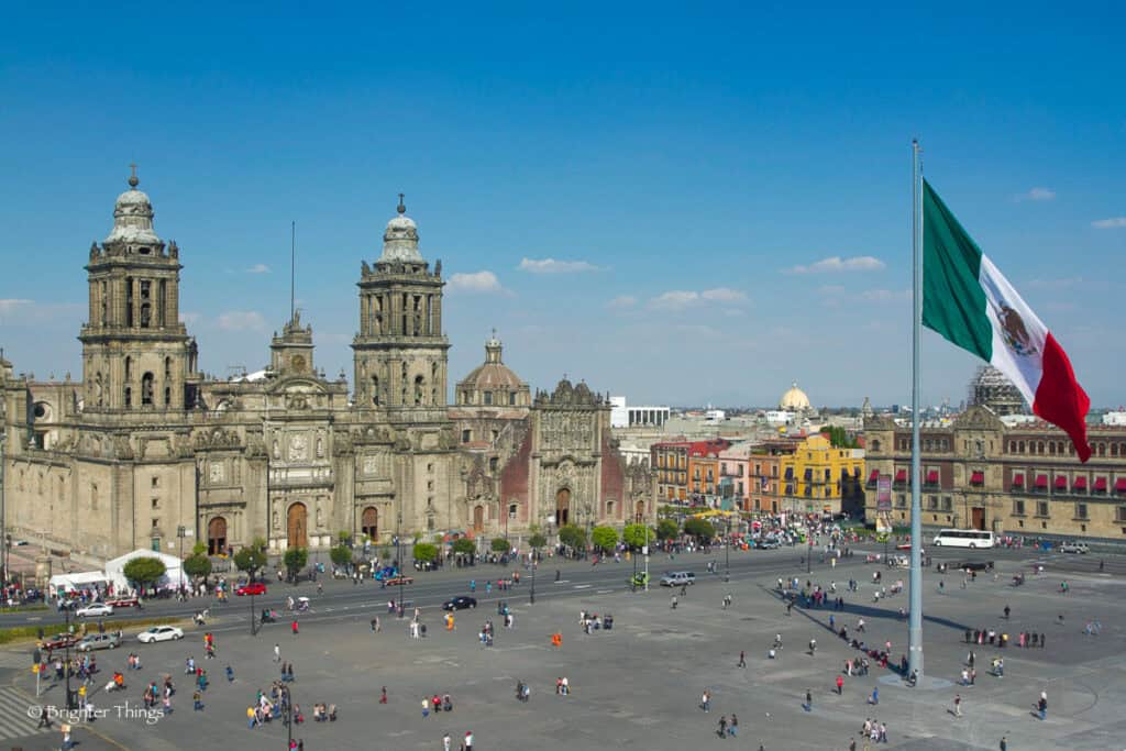 the zocalo in mexico city, with the cathedral and giant flag in the centre