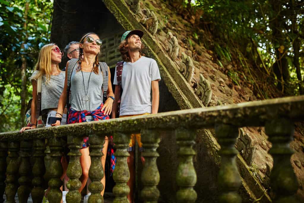 tourist exploring ancient jungle ruins in tropical rain forest on thailand adventure travel