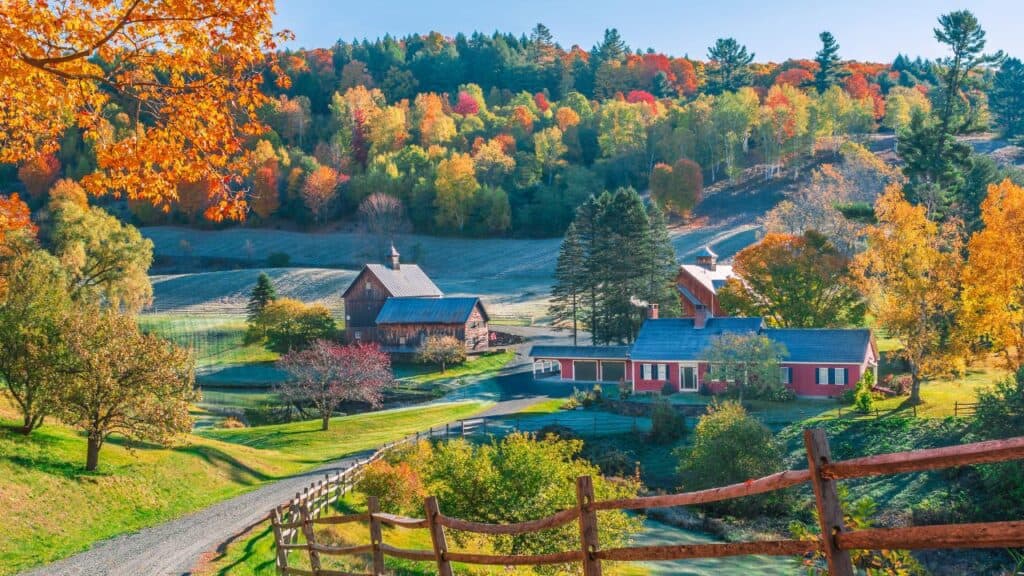 An early autumn foliage scene of houses in Woodstock, Vermont mountains