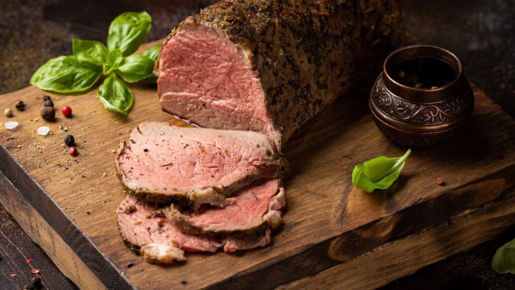 Juicy roast beef with spices sliced on a cutting Board
