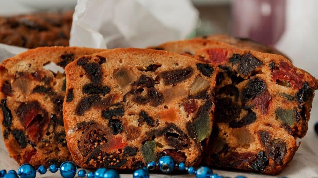 English dried fruitcake. Traditional Christmas cake with almonds, dried fruits, dates, candied Fruits.Fruitcake. concept New year, Christmas spirit and decorations