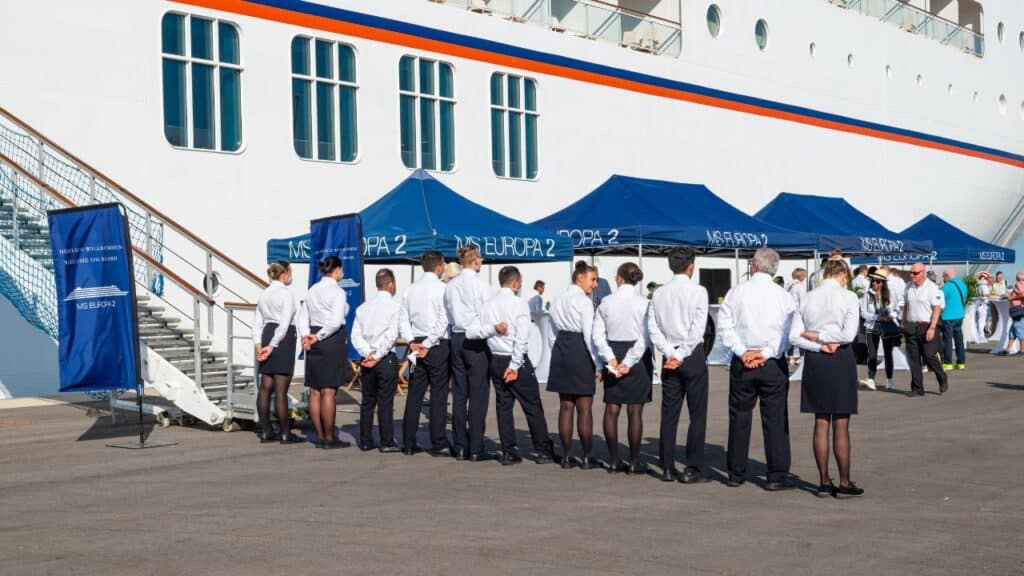 GIUDECCA, VENICE, ITALY - SEPT 2 2022: Crew in a row during welcome reception of the most luxurious cruise ship MS Europa 2, Hapag-LLoyd Cruises. Giudecca, Venice in Italy