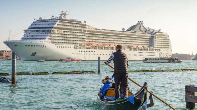 Gondola and cruise ship on a Venetian canal in Venice Italy