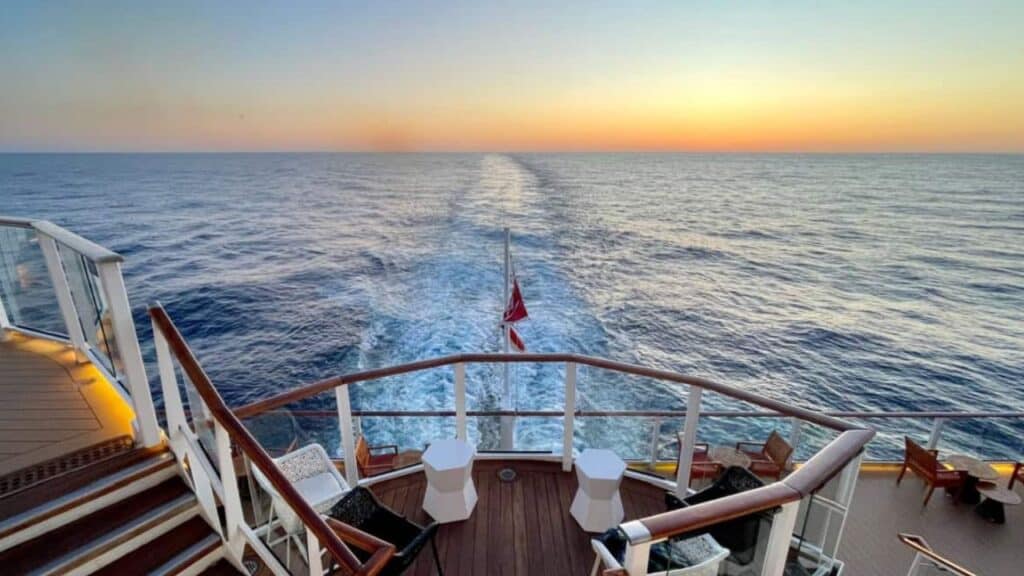 Cruise ship wake with sunrise on the horizon