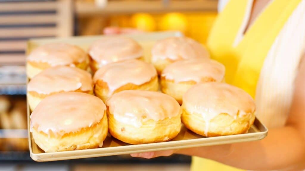 Bakery shopkeeper presents doughnuts