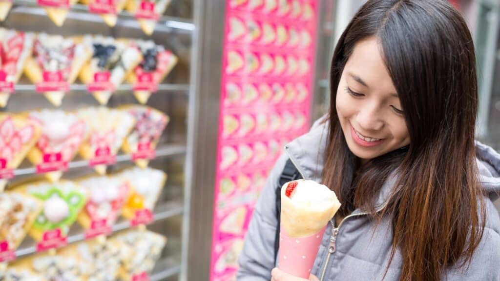Food blogger/influencer eating a trendy crepe