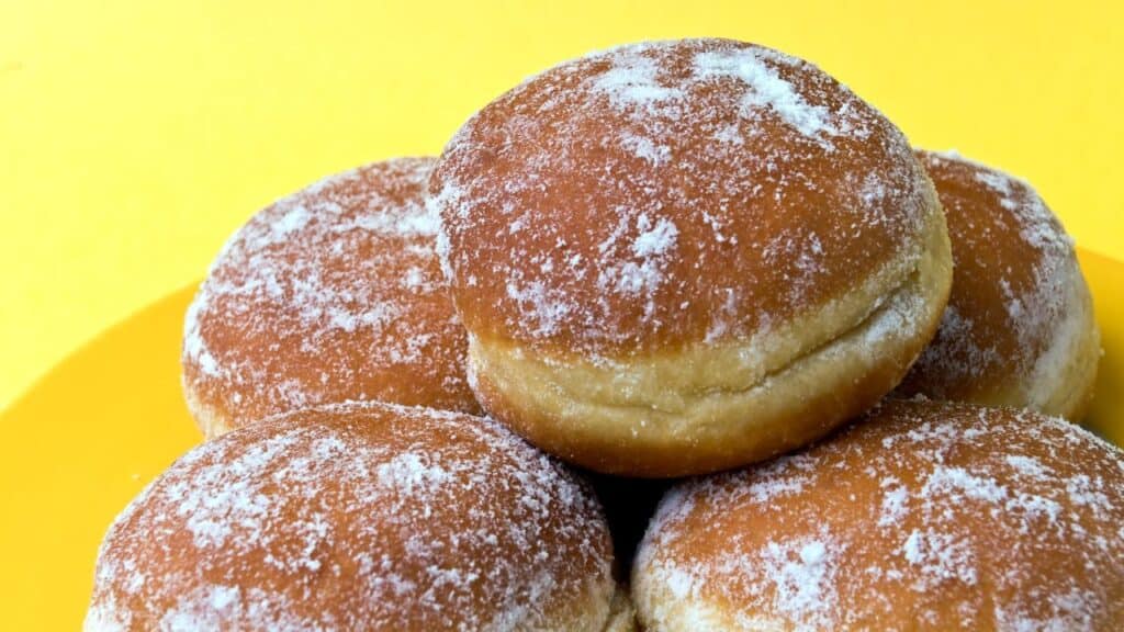Portuguese Donuts, malasadas, stacked on a plate