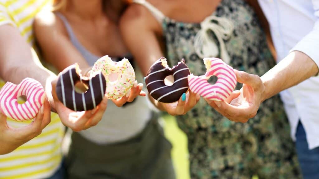 Group of friends eating donuts