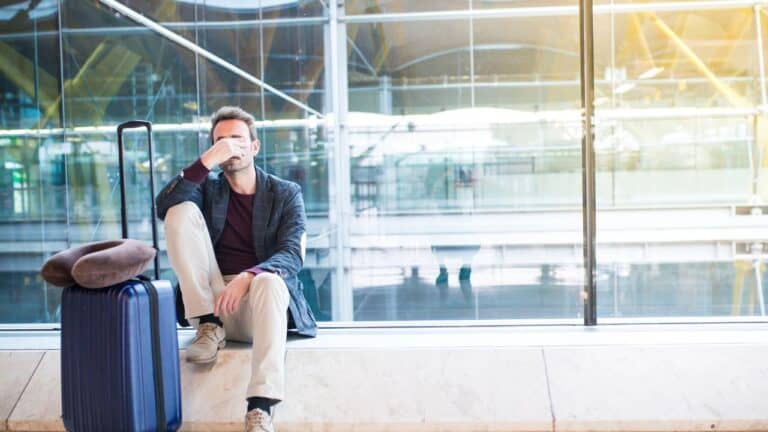 Man upset, sad and angry at the airport his flight is delayed