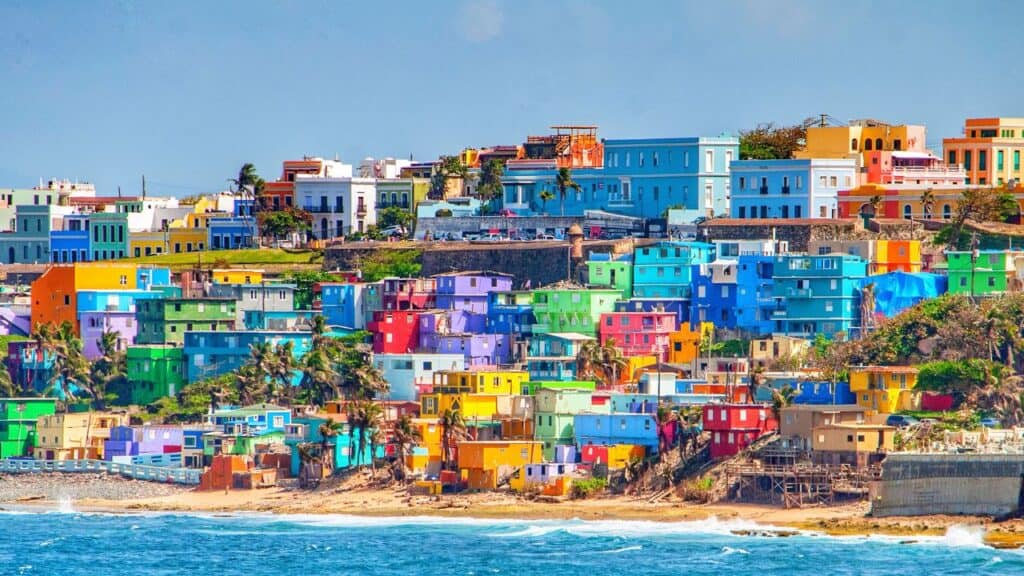 Colorful houses line the hillside over looking the beach in San Juan, Puerto Rico
