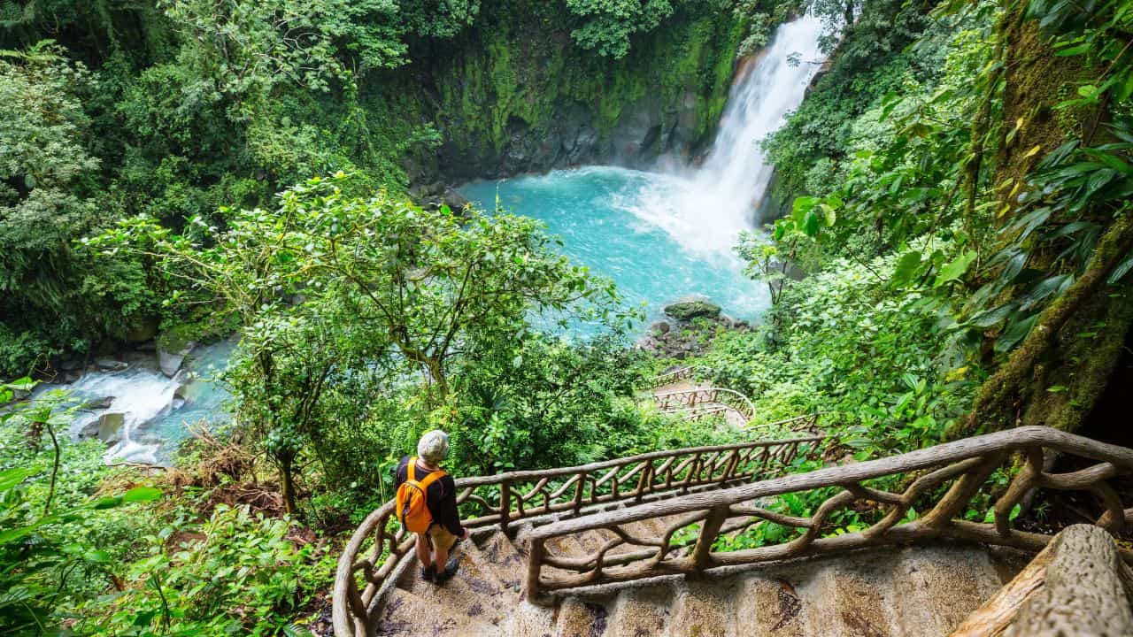 Majestic waterfall in the rainforest jungle of Costa Rica. Tropical hike.
