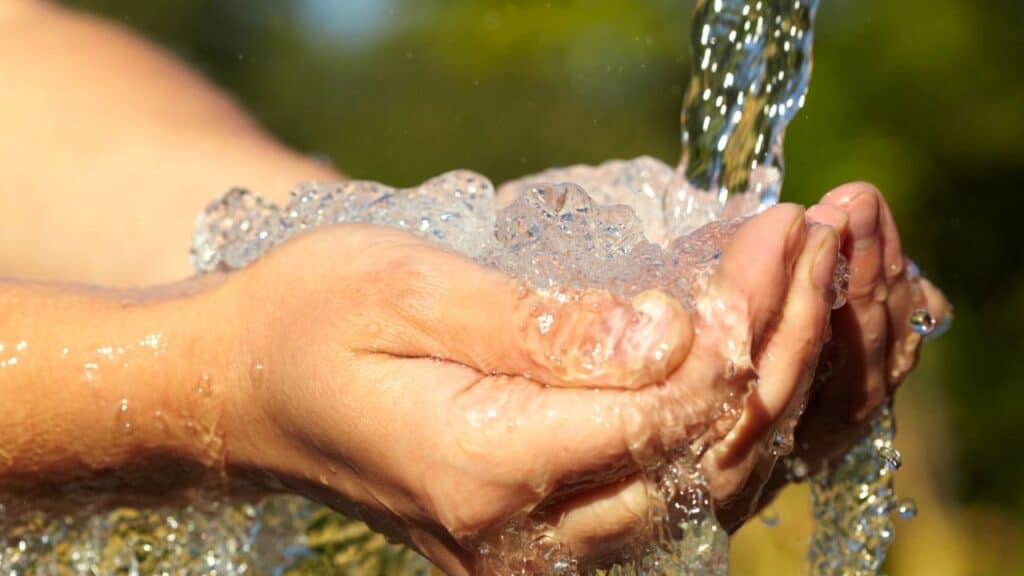 Woman's hands with water splash
