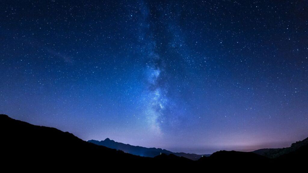Night sky stars. Milky Way. Mountain background