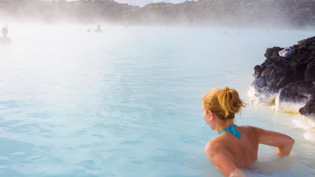 Beautiful young woman in Blue Lagoon geothermal spring , Iceland