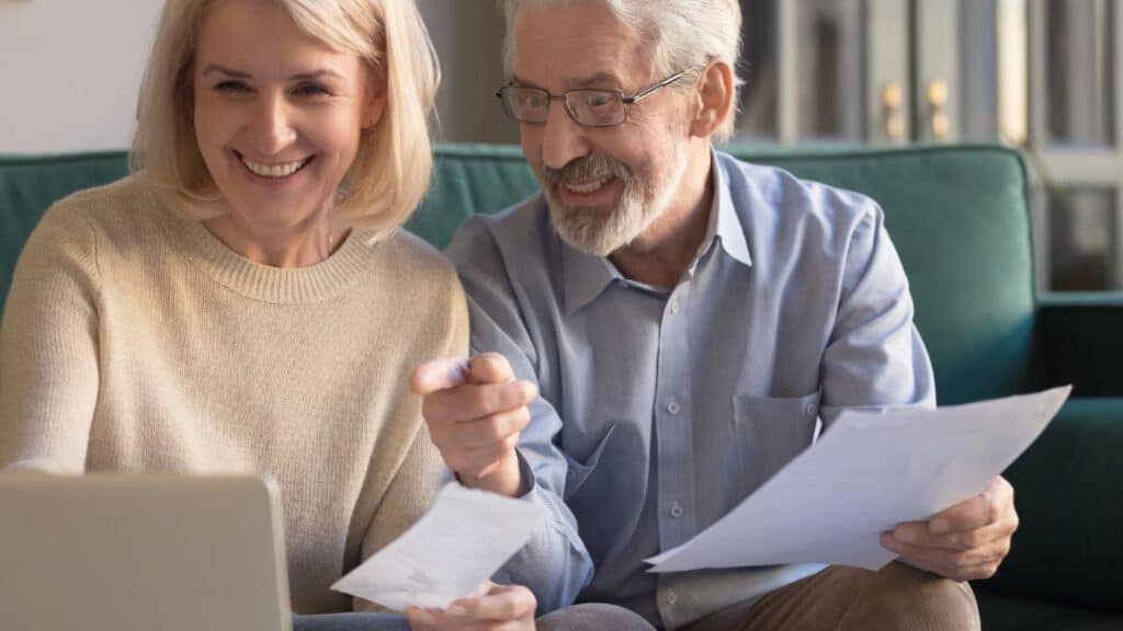 Older couple planning a trip on a laptop