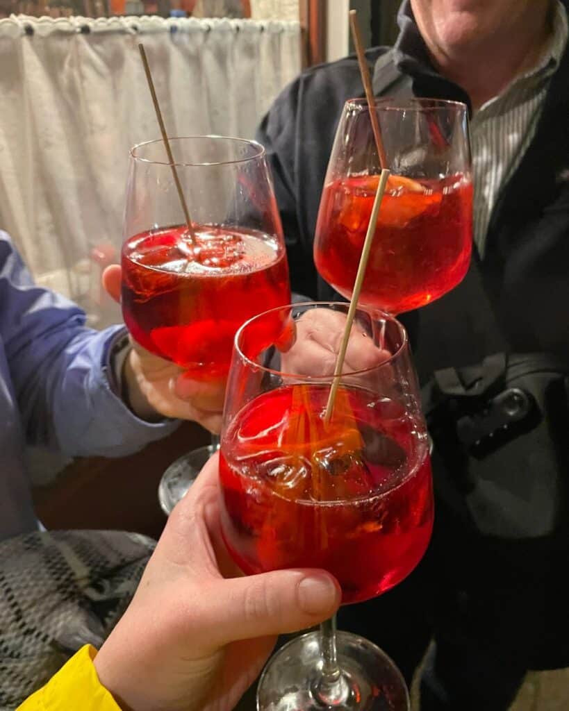 Three glasses of aperol spritzes in Venice Italy