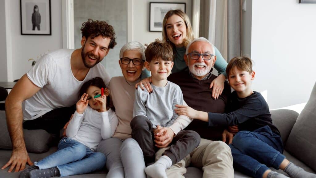 Multigenerational travel family posing for a picture on a couch